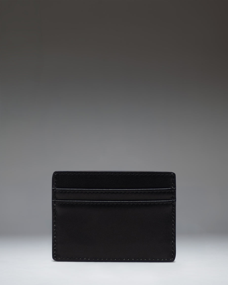 Herschel Supply Co Charlie Cardholder Leather in black. Minimalist wallet featuring multiple card slots and a top sleeve pocket.