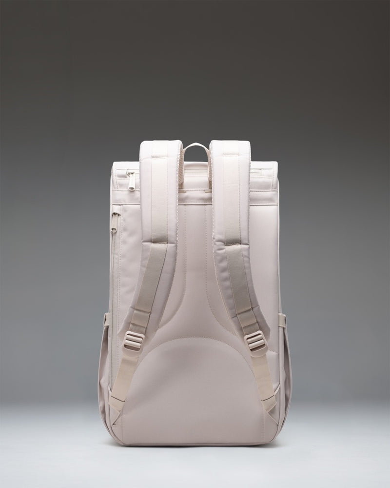 Herschel Little America Backpack in Moonbeam, a minimalist light grey daypack with matching rubber straps, magnetic closures, and front pocket.