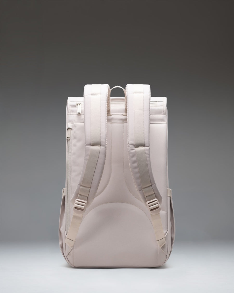 Herschel Little America Backpack in Moonbeam, a minimalist light grey daypack with matching rubber straps, magnetic closures, and front pocket.