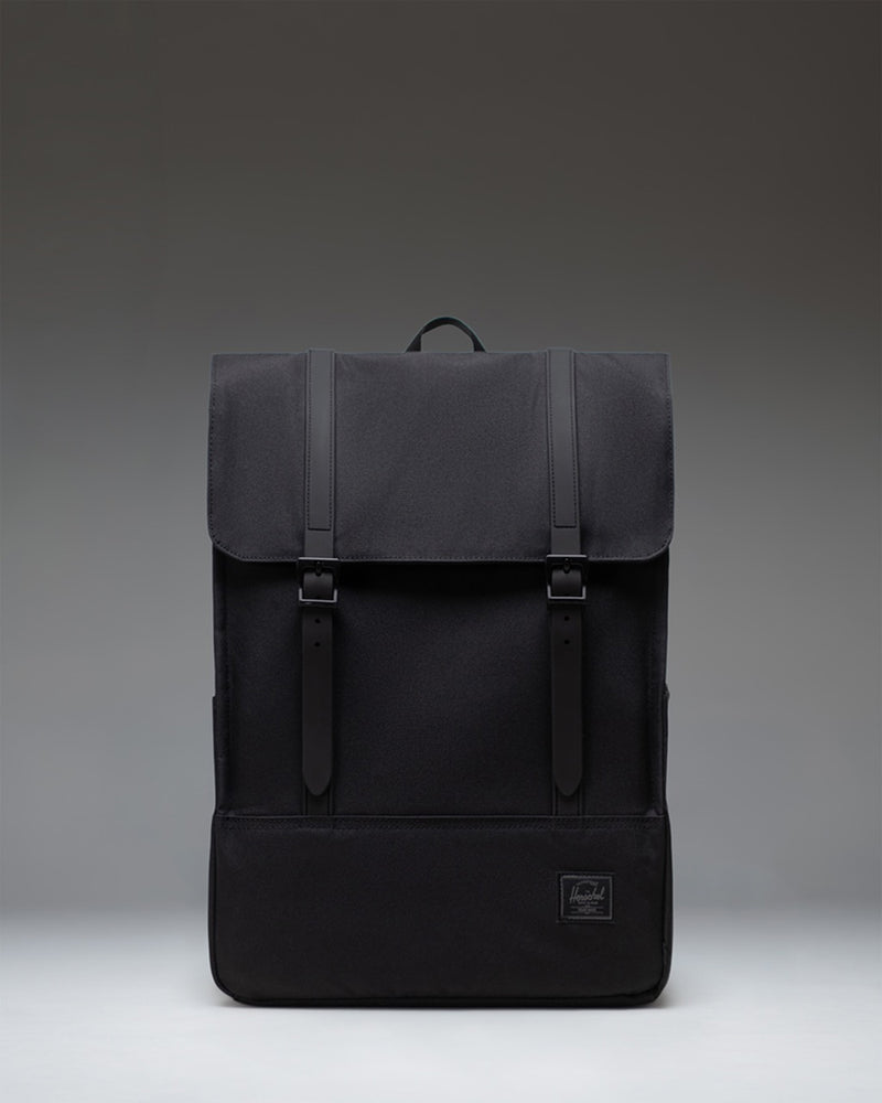 Herschel Survey Backpack in Black Tonal, showing the front view of the minimalist bag with dual straps.