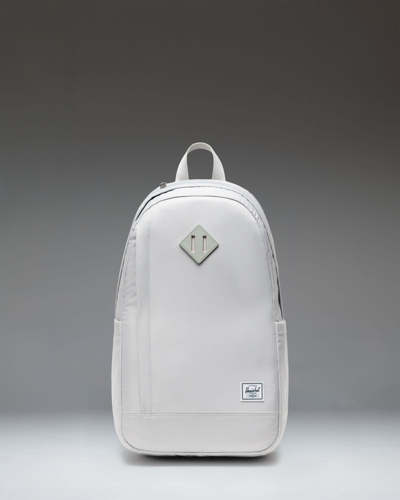 Herschel Supply Co. Seymour Backpack in Metal. Front view of the grey backpack with a front zipper pocket and classic Herschel logo.