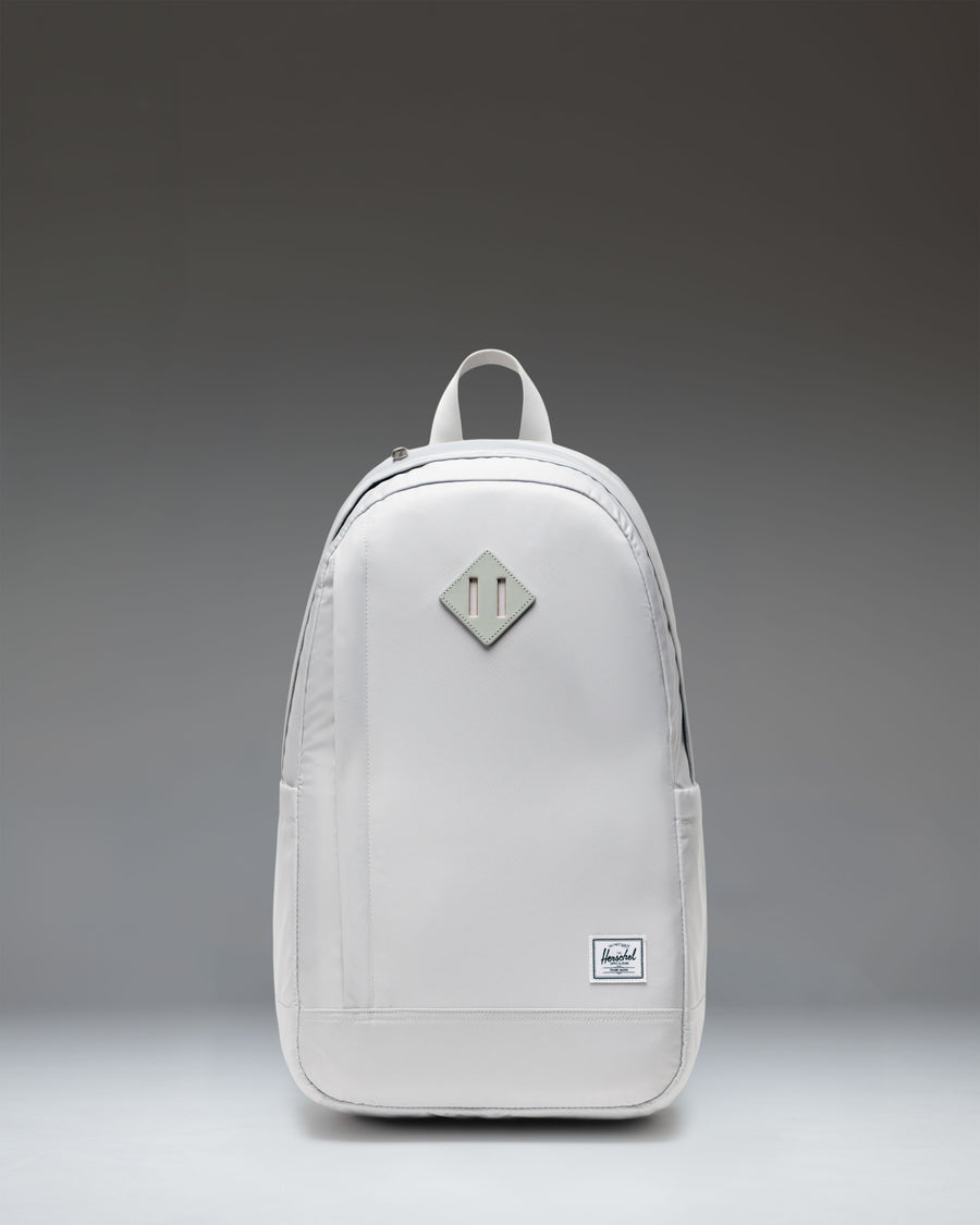 Herschel Supply Co. Seymour Backpack in Metal. Front view of the grey backpack with a front zipper pocket and classic Herschel logo.