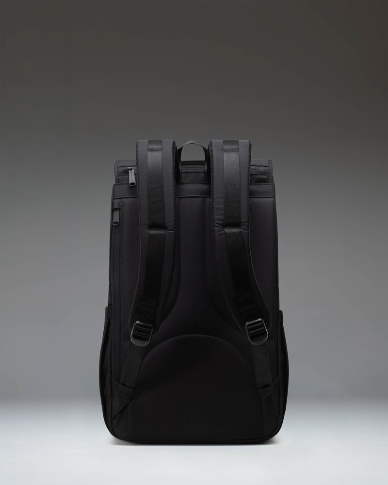Herschel Little America Backpack in black, showcasing its classic mountaineering style with dual rubber straps and front pocket.