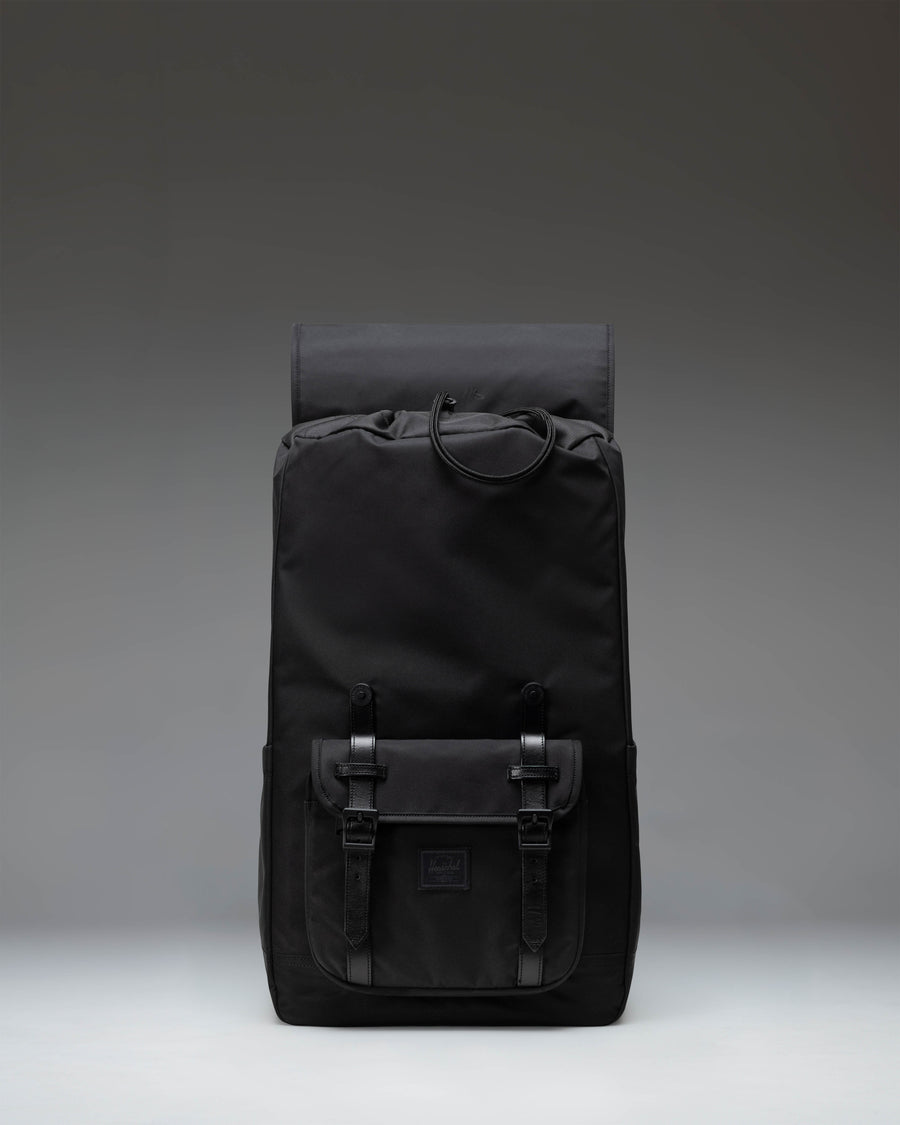 Black Herschel Little America Backpack featuring a classic mountaineering design with dual magnetic strap closures and a front storage pocket.