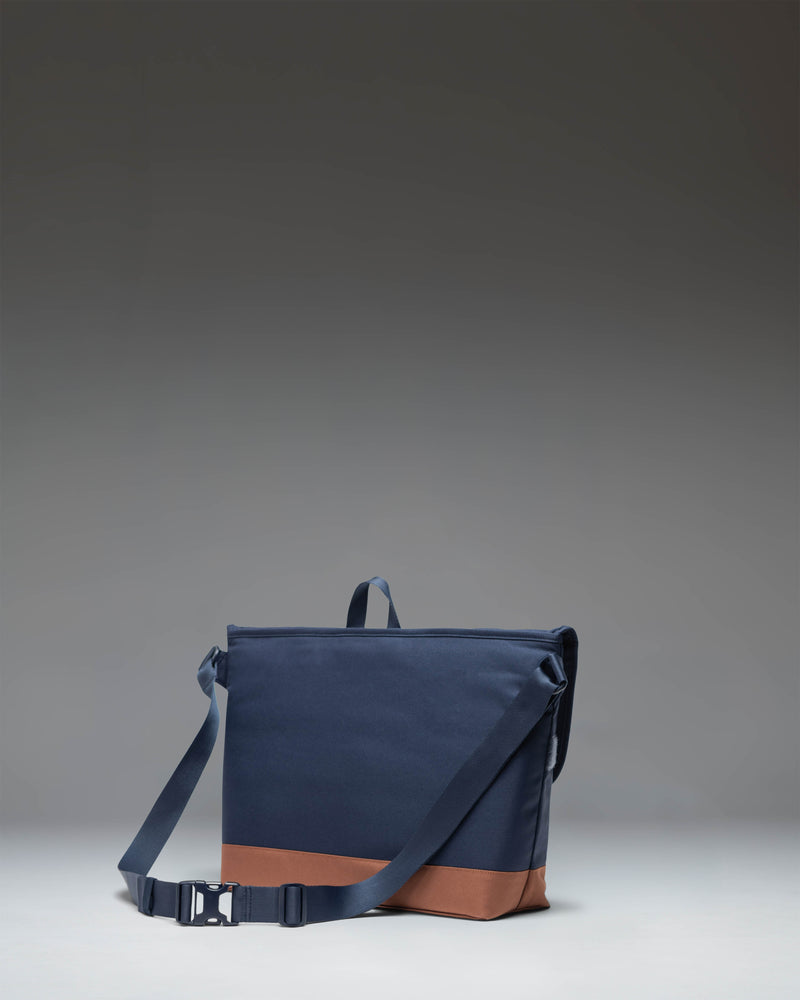 Herschel Supply Co. Cove Messenger bag in Navy with Saddle Brown details.