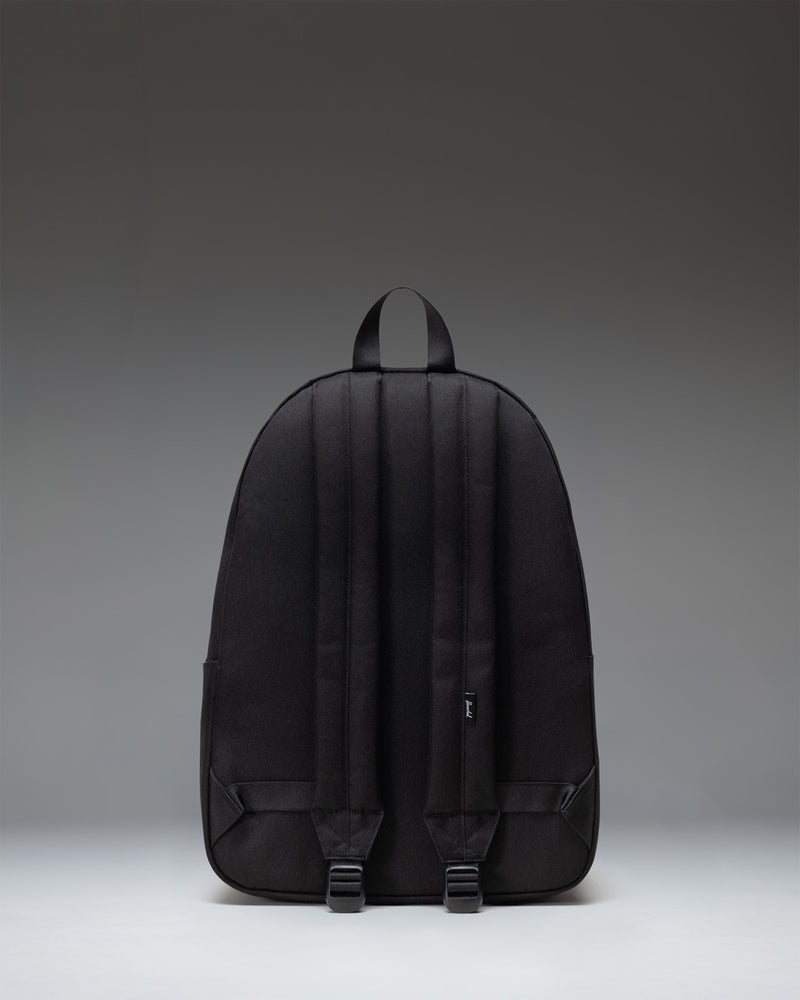 Herschel Classic XL Backpack in Black, featuring a spacious main compartment, front storage pocket, and classic woven label.
