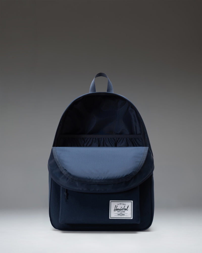 Herschel Supply Co. Classic XL Backpack in Navy, featuring a spacious main compartment, front storage pocket, and classic woven label.