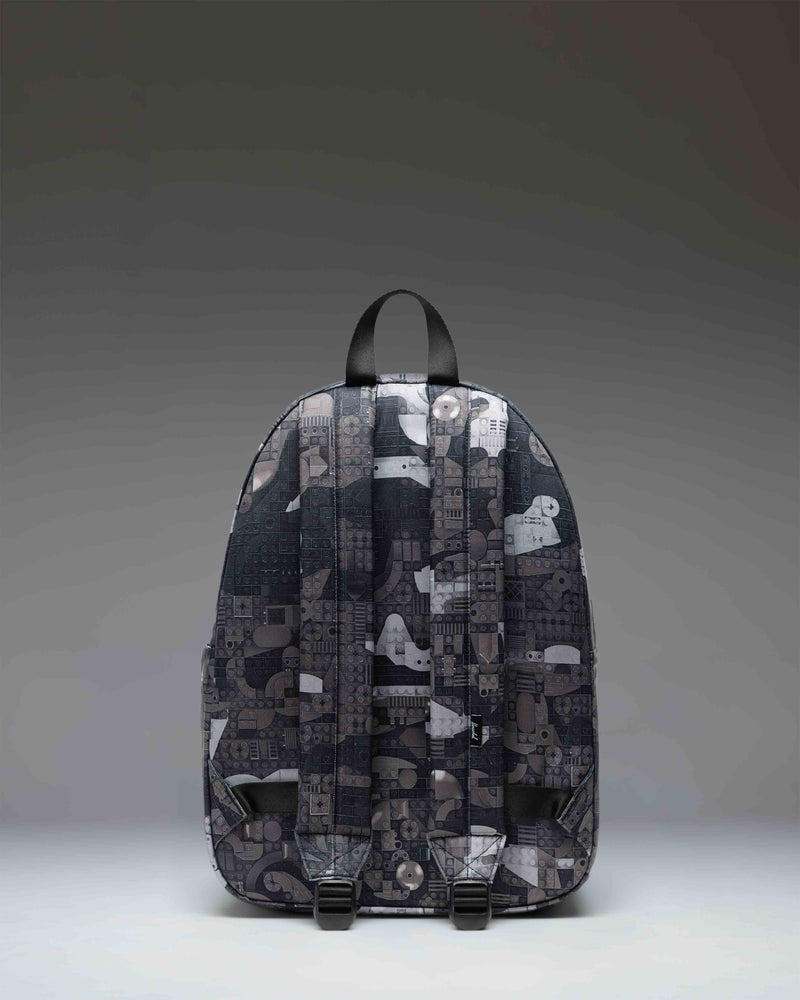 LEGO Herschel Classic Backpack in Abstract Bricks Black featuring a colorful LEGO brick pattern on a black background.