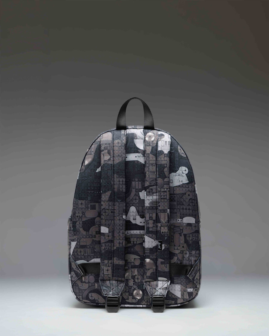 LEGO Herschel Classic Backpack in Abstract Bricks Black featuring a colorful LEGO brick pattern on a black background.