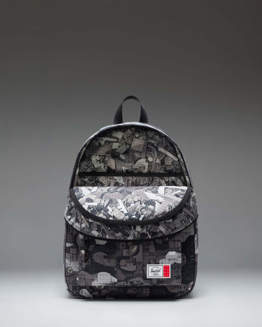Herschel Supply Co. LEGO Classic Backpack in Abstract Bricks Black featuring a black body with subtle colorful LEGO brick outlines.