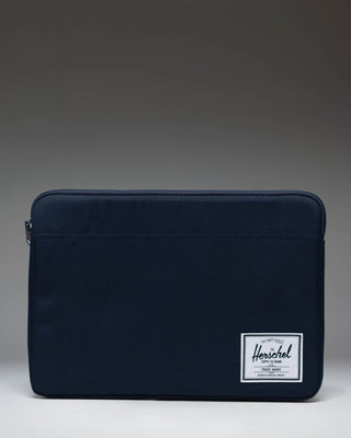 Herschel Supply Co Anchor 14 inch laptop sleeve in solid navy blue with a classic woven logo label on the bottom corner.