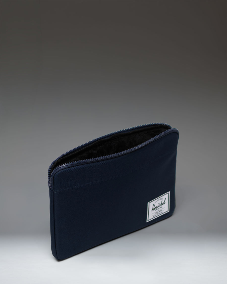 Herschel Supply Co. Navy Anchor 14 Inch Sleeve laptop case shown from a front angle on a white background.