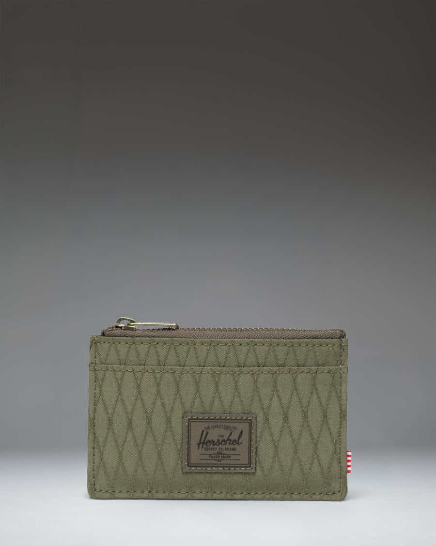 Herschel Supply Co. Oscar Cardholder in Ivy Green Diamond featuring a slim design with card slots and a zipped main compartment.