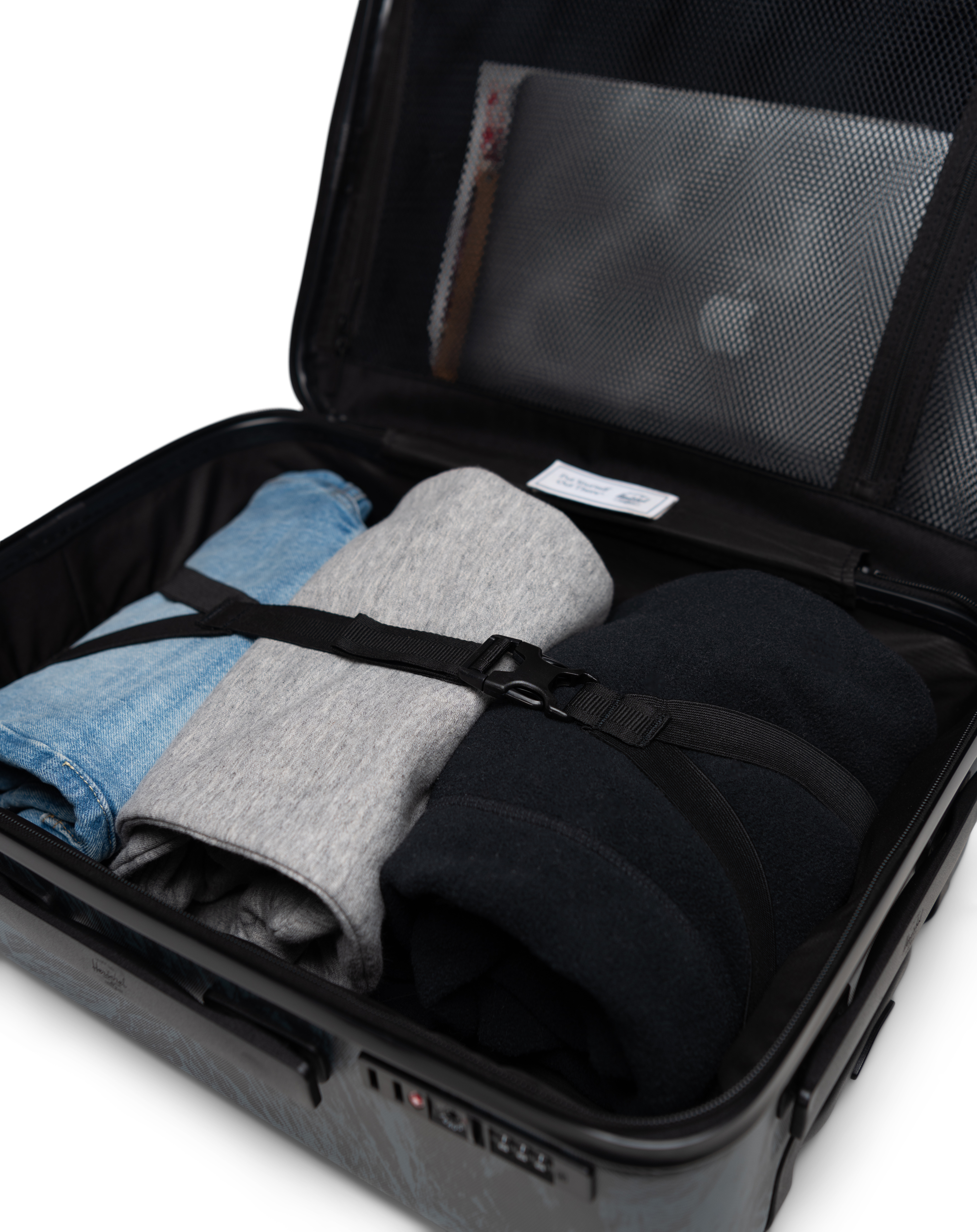 Herschel Heritage Hardshell Large Carry On Luggage feature diagram showing the split design interior with mesh storage and garment straps.