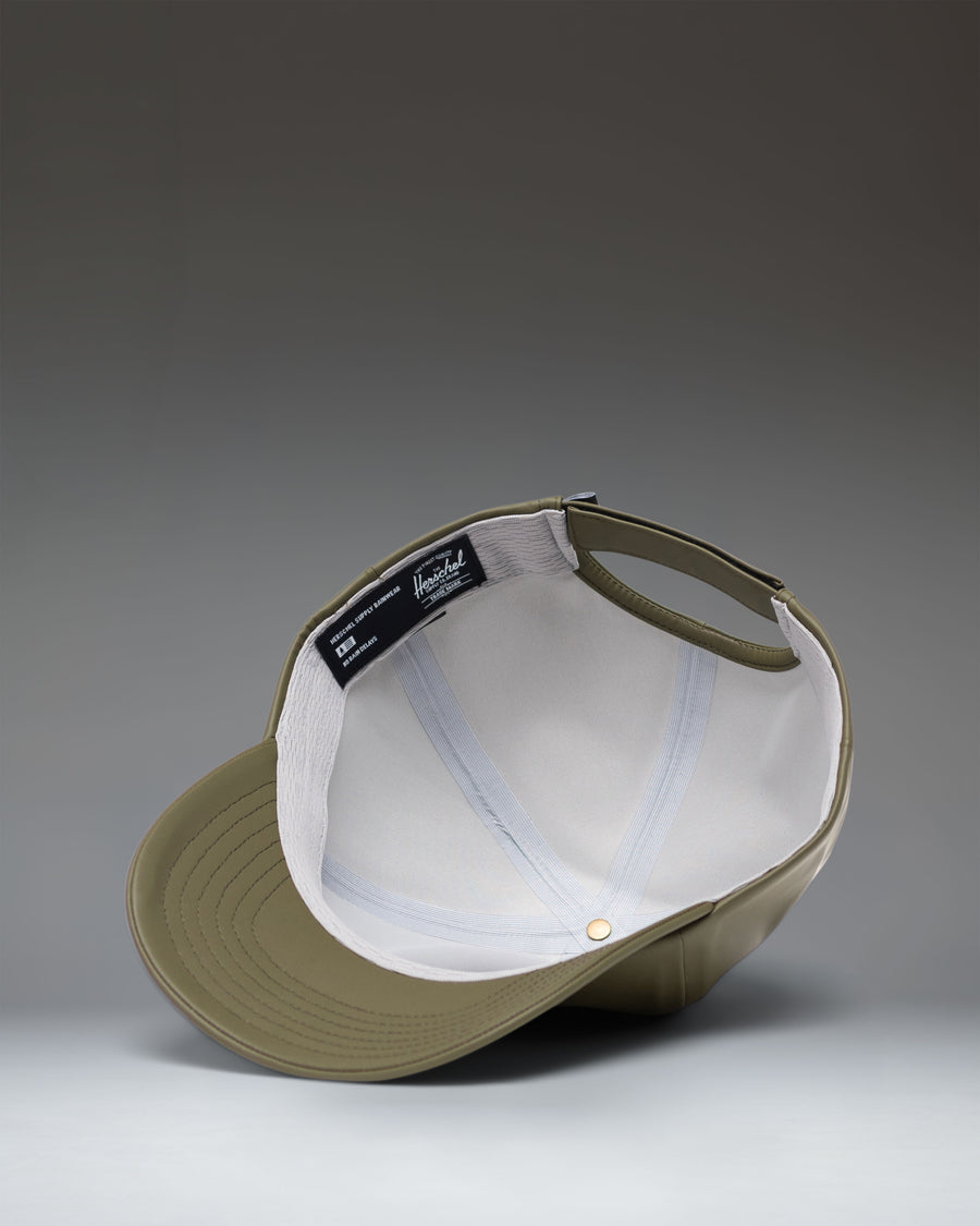 Herschel Supply Co. Sylas Rain Cap in Ivy Green, a water-resistant baseball cap with an adjustable strap.
