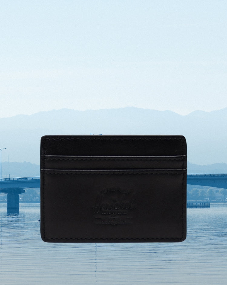 Herschel Supply Co. Charlie Cardholder Leather in classic black, a sleek and compact minimalist wallet featuring multiple card slots.
